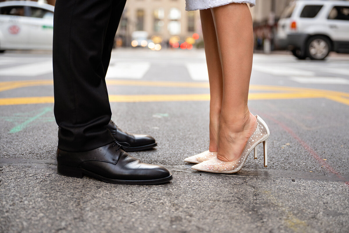 Detail shot of newlyweds shoes in the middle of street in Chicago