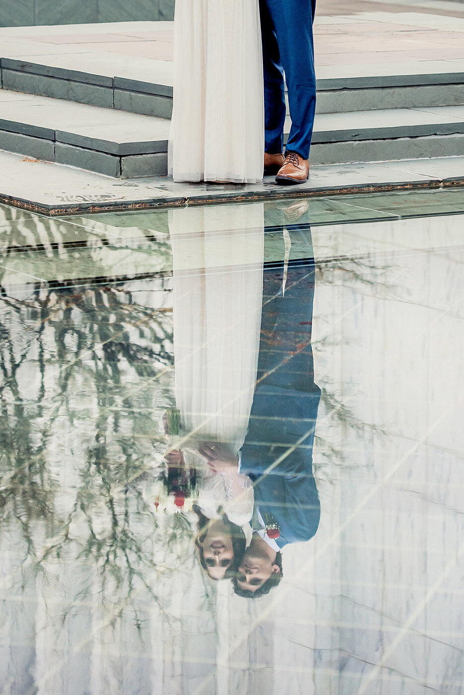 couple with reflection in water