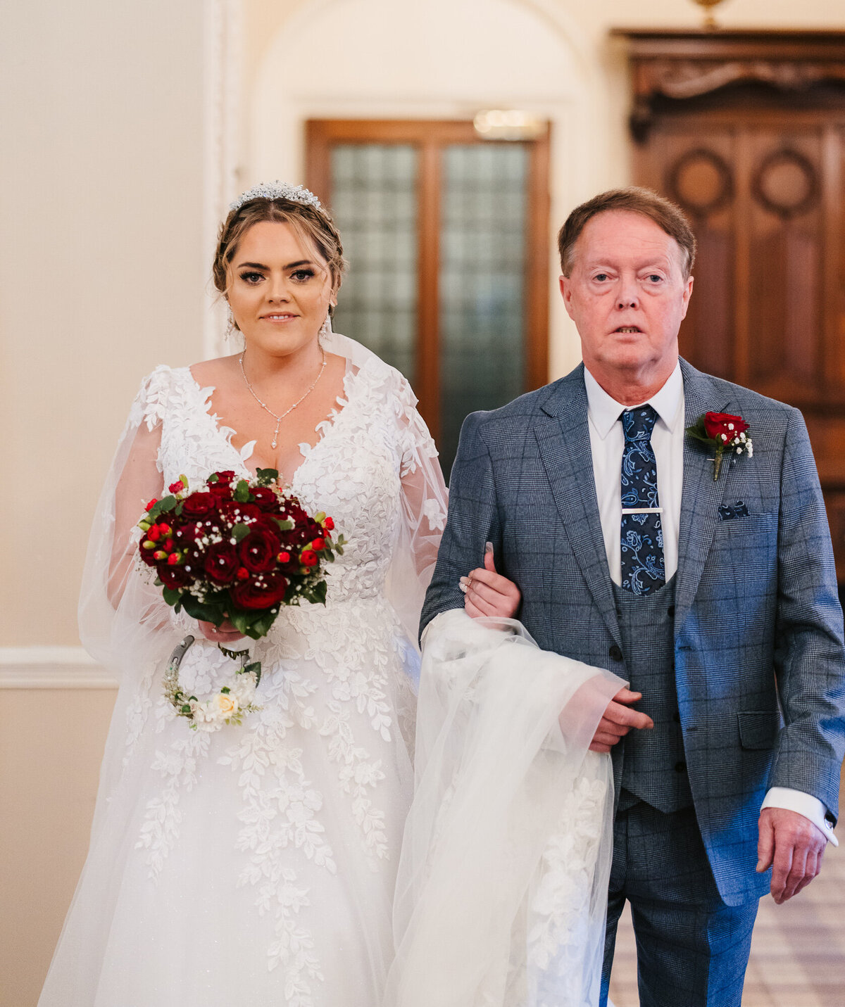 Father of the bride and bride entering the ceremony room at Merewood Country House Hotel in the Lake District taken by Anthony Horseman wedding photographer