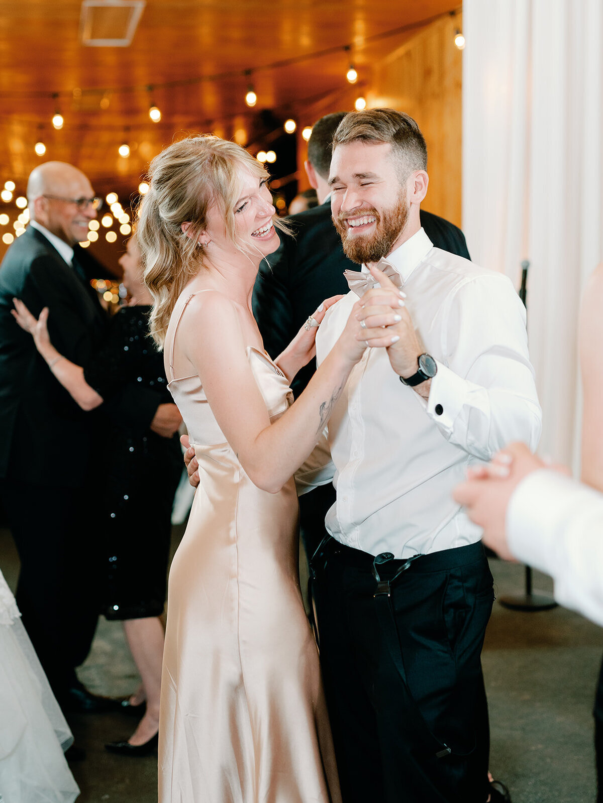 Guest smile and dance at wedding reception at salamander resort