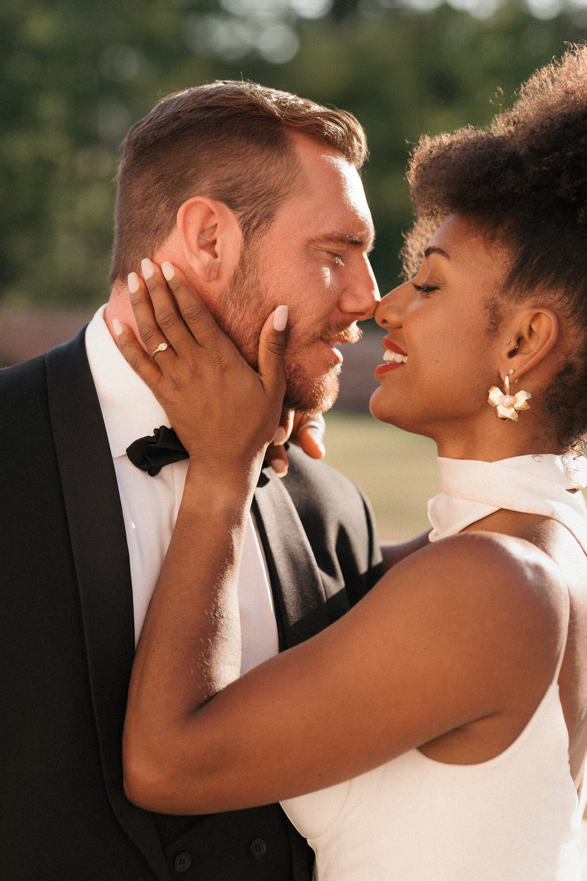 A bride and groom almost kissing at heights house raleigh.