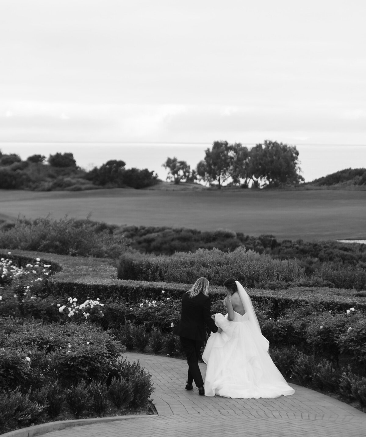 Bride and groom walking along in the country