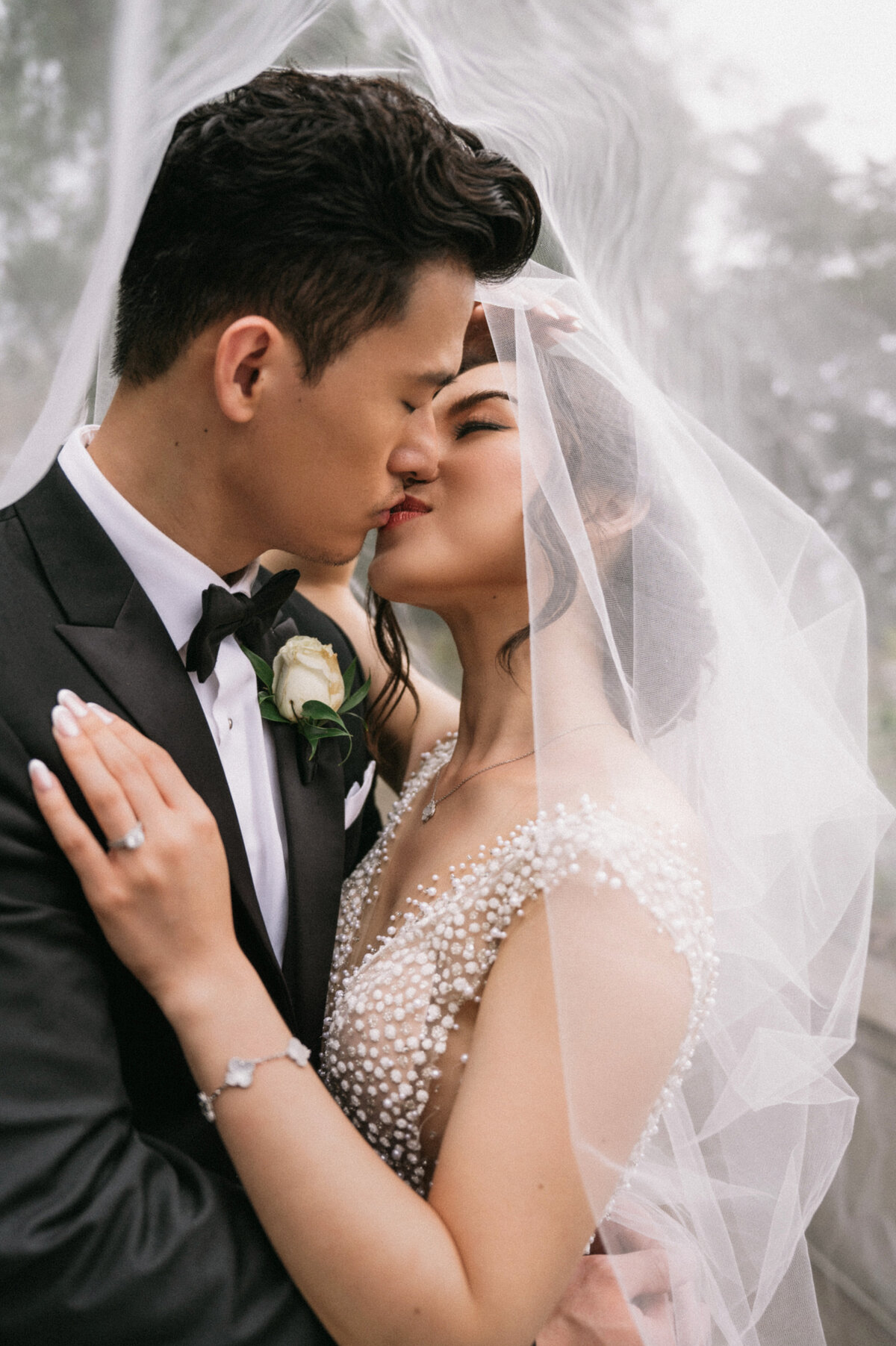 groom kissing bride under the veil