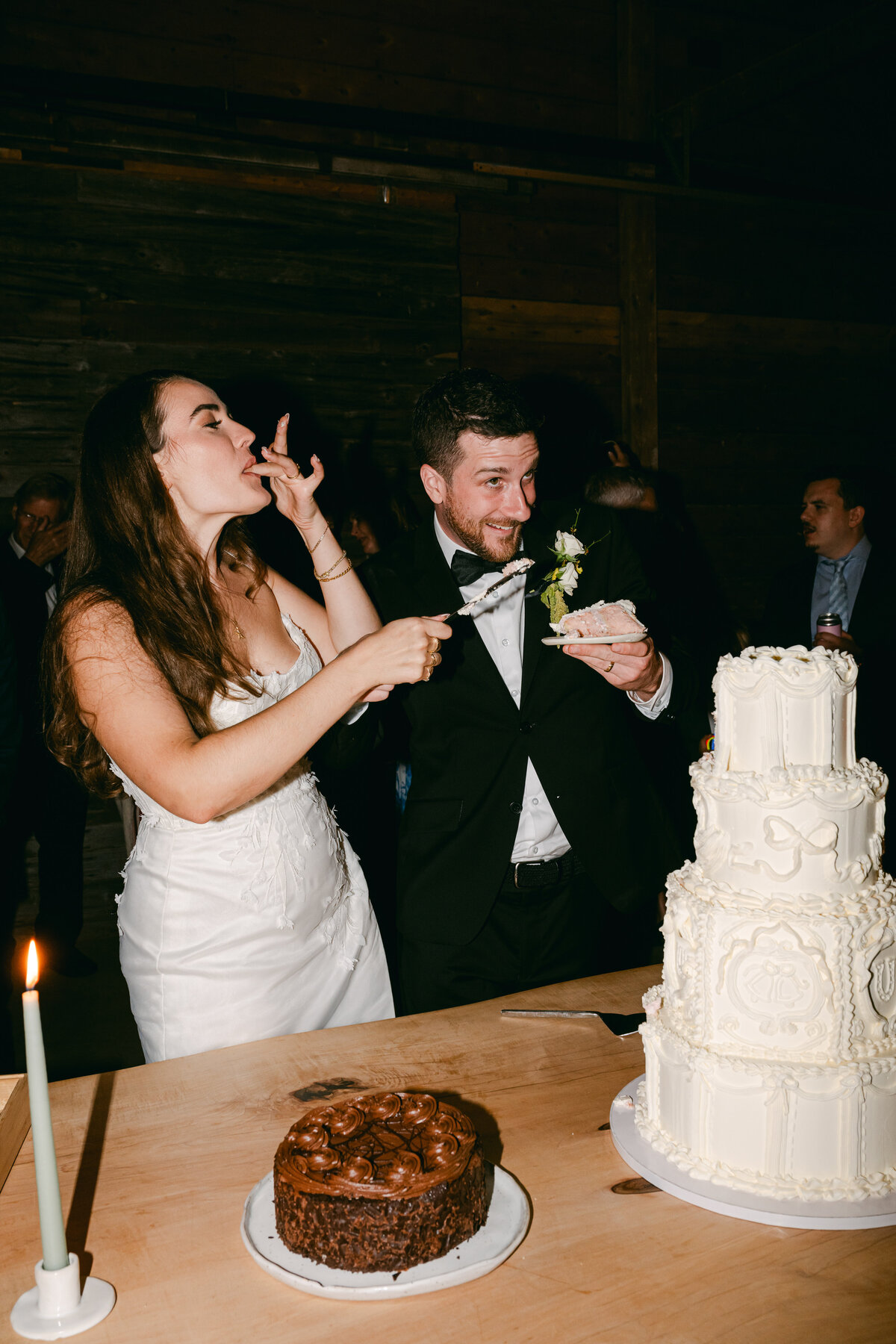 A couple cutting their wedding cake with enthusiasm