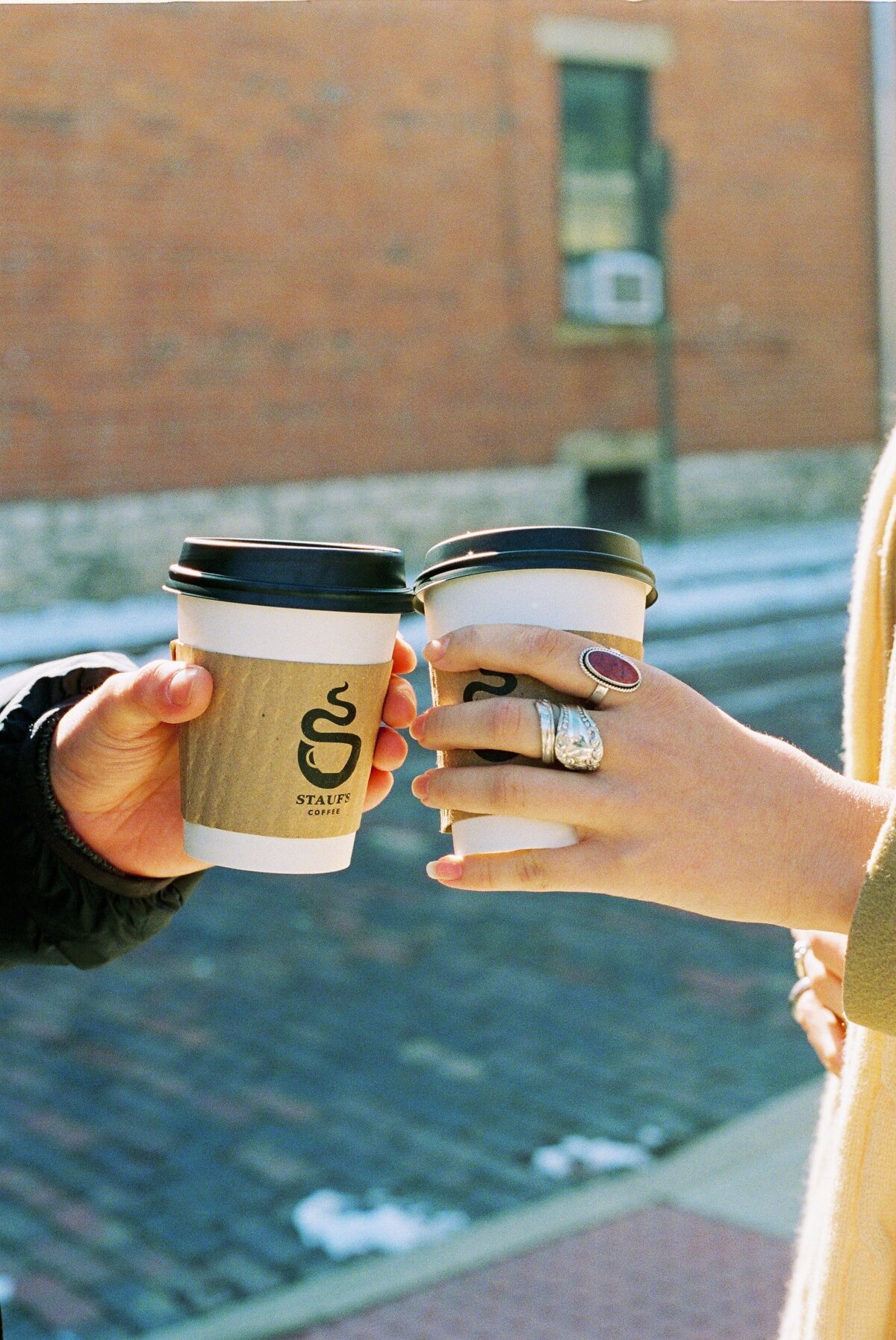 couple holding coffee cups