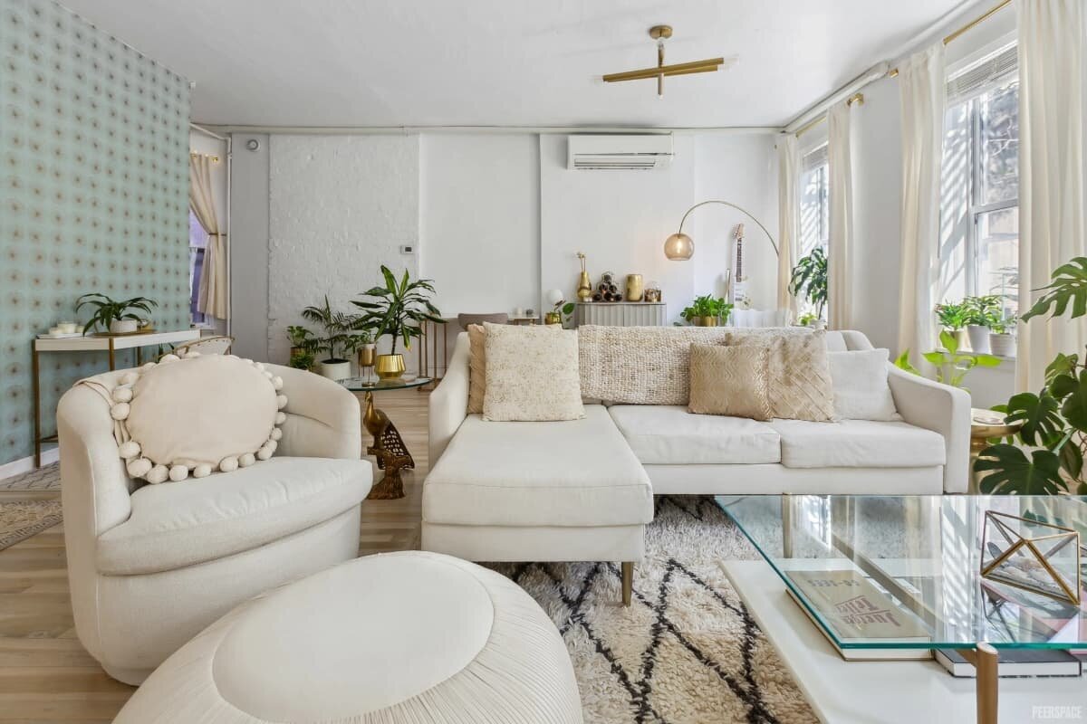 Cozy NYC studio living room with modern furniture, neutral tones, and natural light for photoshoots.