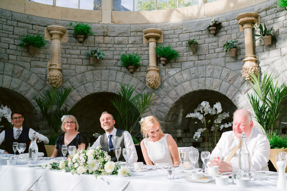 the head table laughing during the speeches