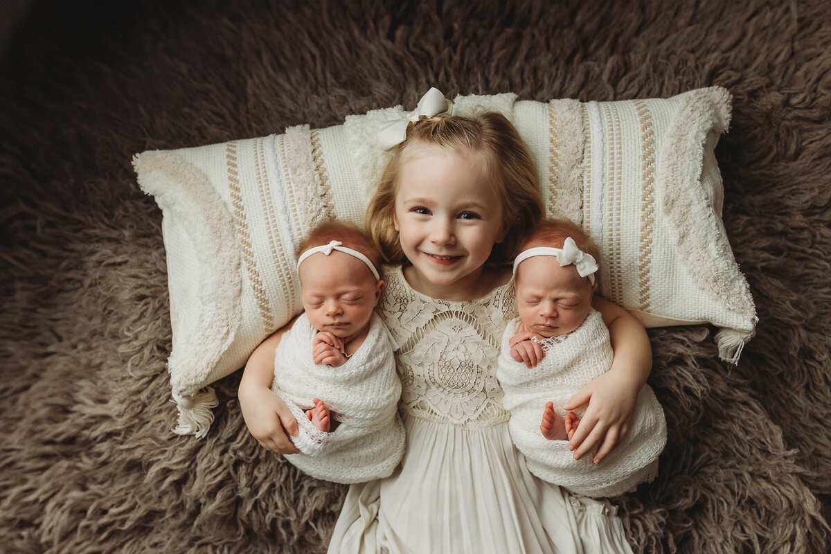 mn-newborn-photography-studio-sister-holding-baby