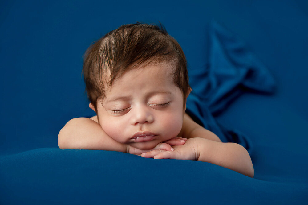 newborn baby boy on a blue background.