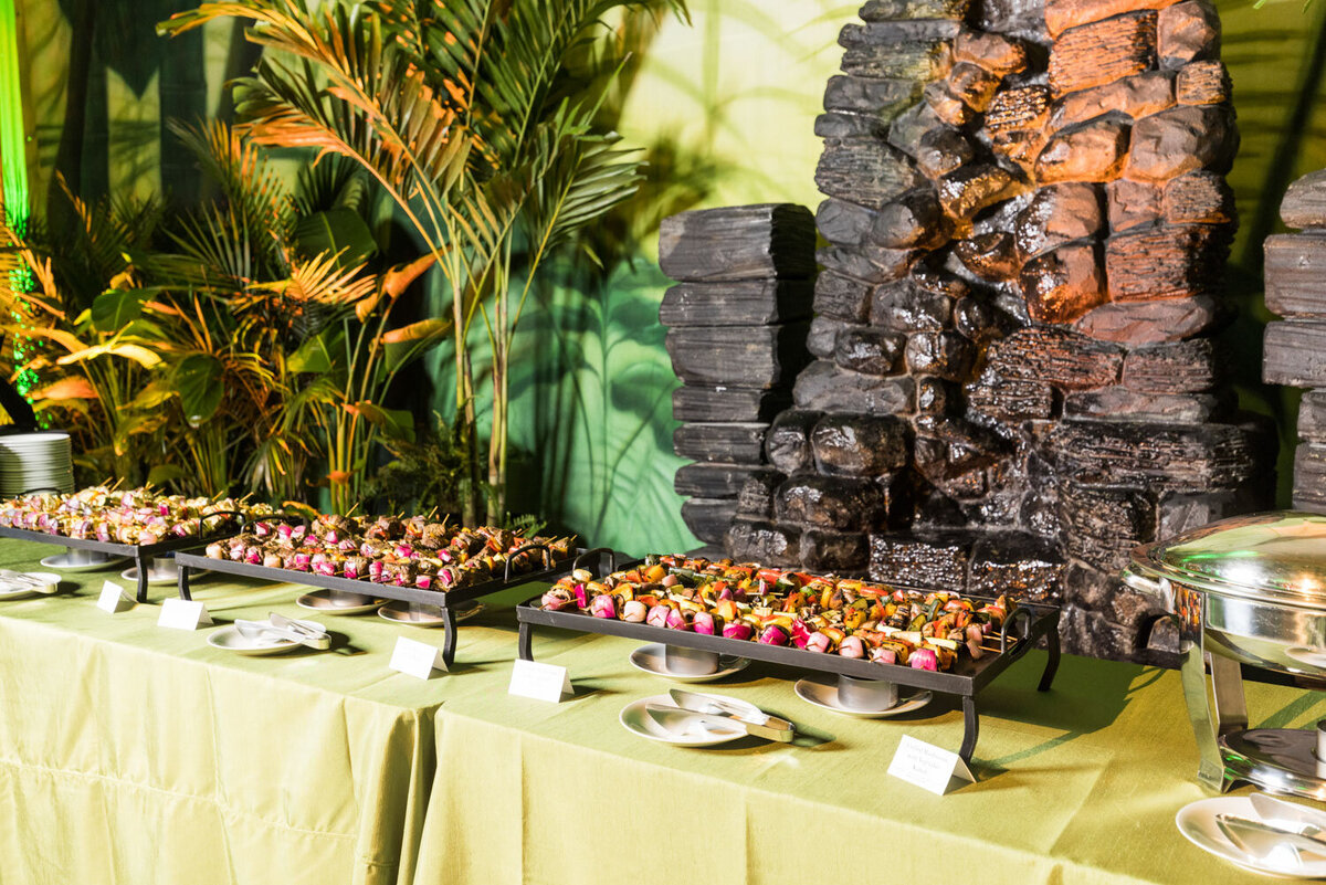 Appetizer trays with skewers by a waterfall display