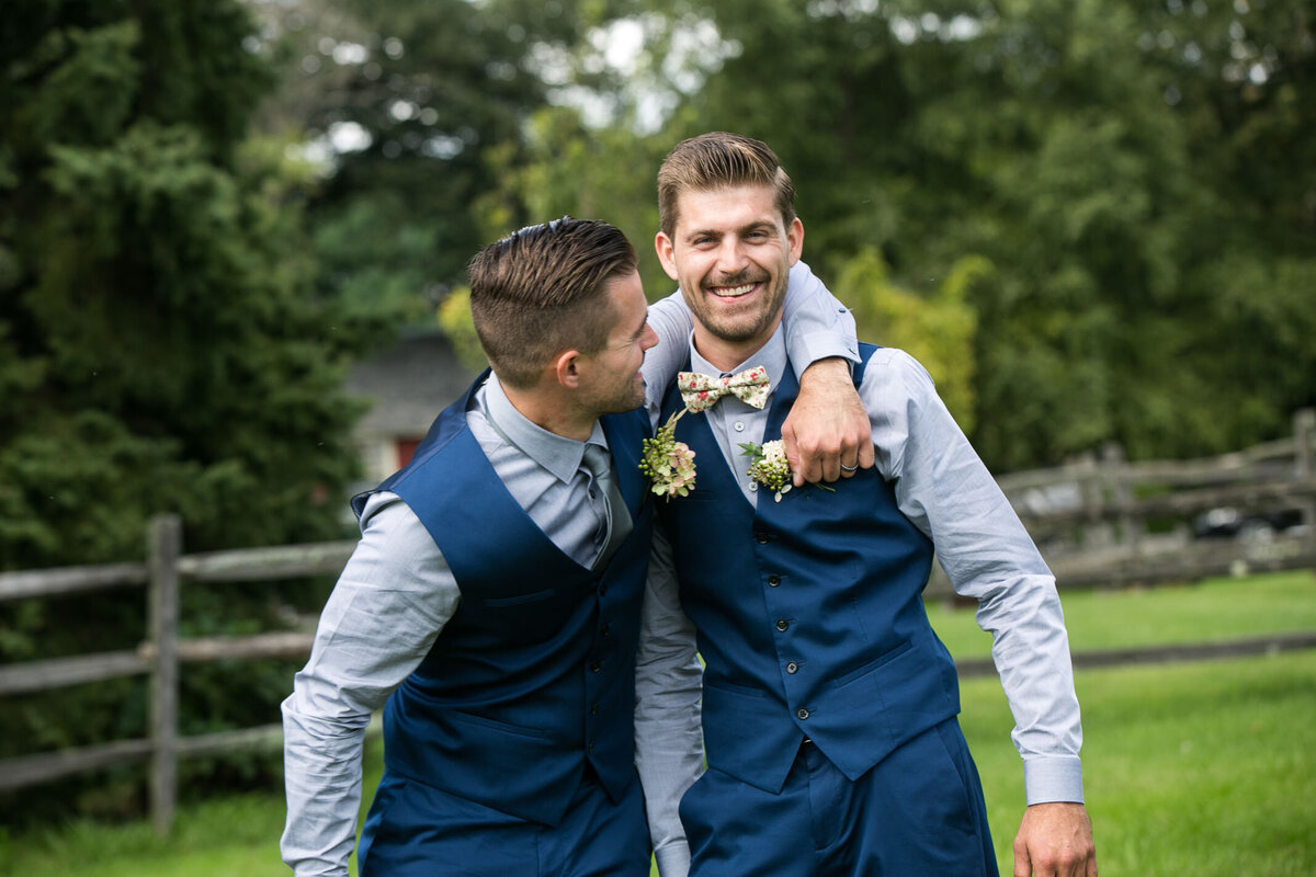 Groom getting a hug from his best man during grooms portraits.  New Hope Pennsylvania