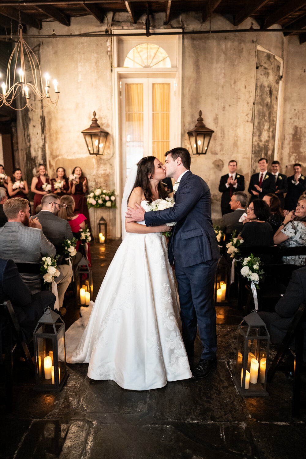 Bride and groom kiss at end of wedding ceremony
