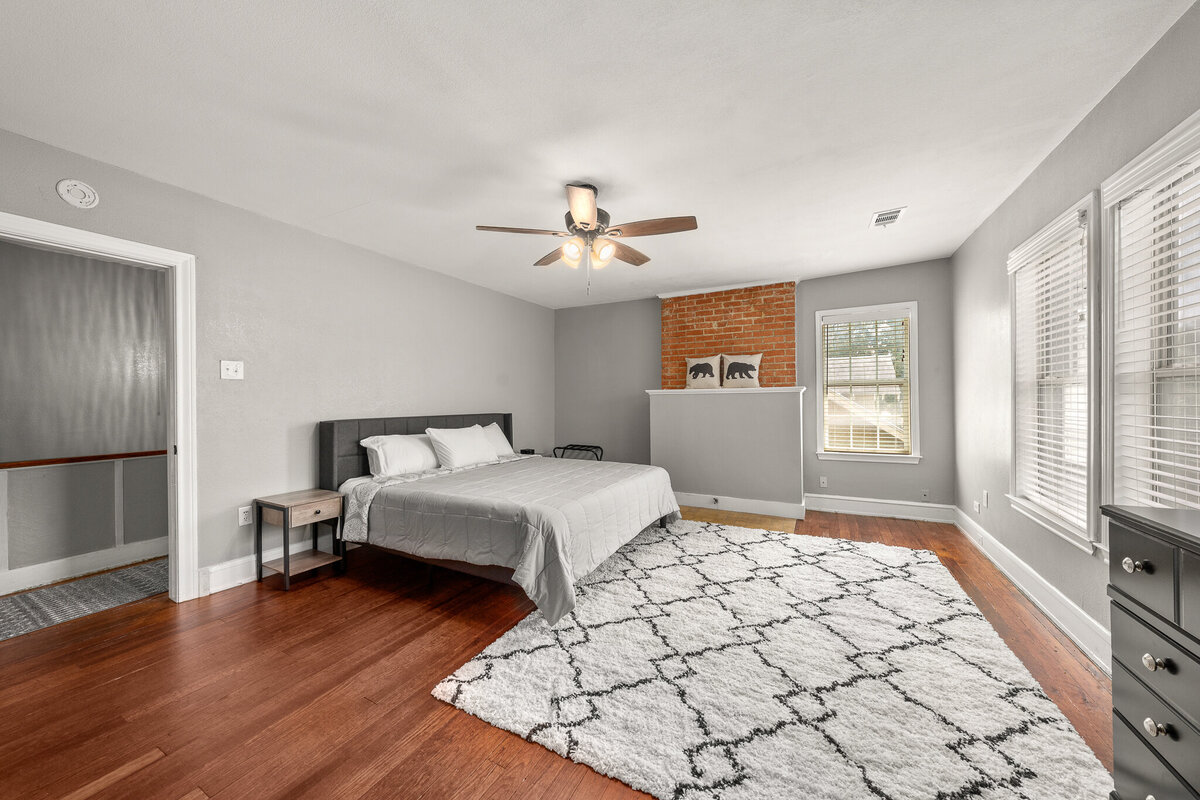 Spacious bedroom with king bed and ample natural light in this five-bedroom, 4-bathroom pet-friendly vacation rental house for 12 guests with free wifi, free parking, hot tub, mother-in-law suite, King beds and updated kitchen in downtown Waco, TX.