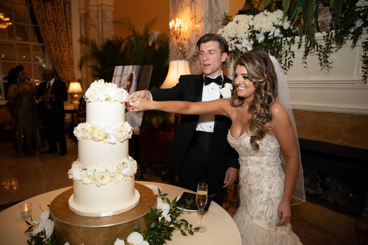 Bride and Groom cutting wedding cake.