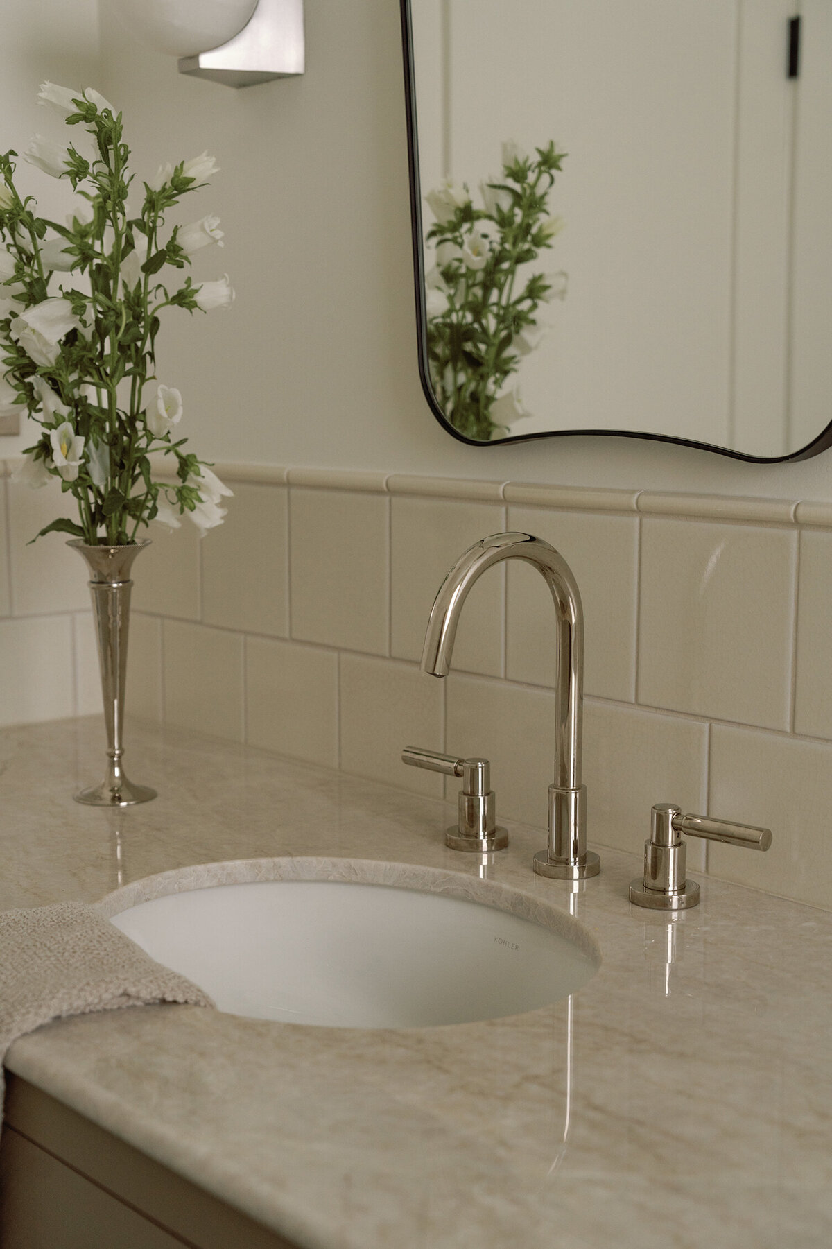 House-Franc-historical-bathroom-remodel-renovation-green-bronze-vanity-taj-mahal-quartzite-countertops-nickel-bell-flowers-fireclay-tile-crackle-tile-traditional-modern-bathroom-oval-sink-phylrich-bronze-knobs-warm-cozy-austin-texas