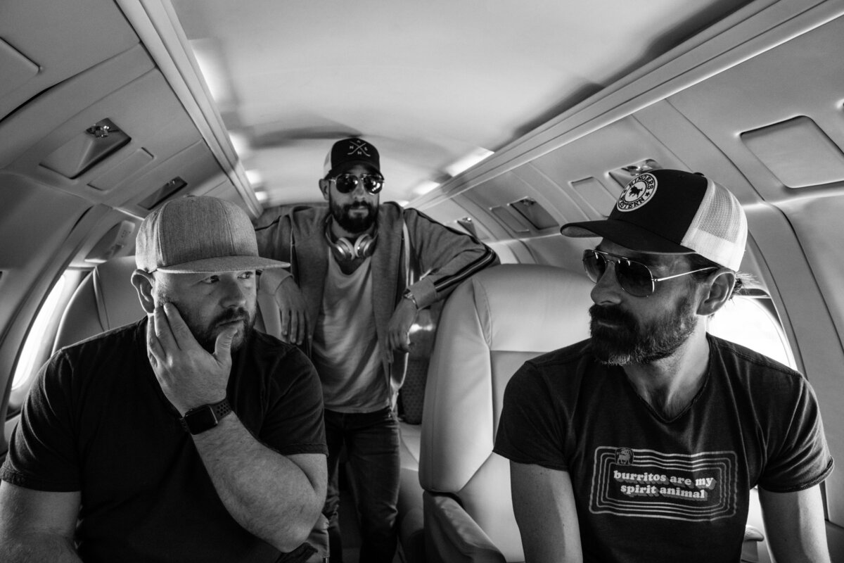 Tommy Garris, Matthew Ramsey and Geoff Sprung traveling by airplane to concert