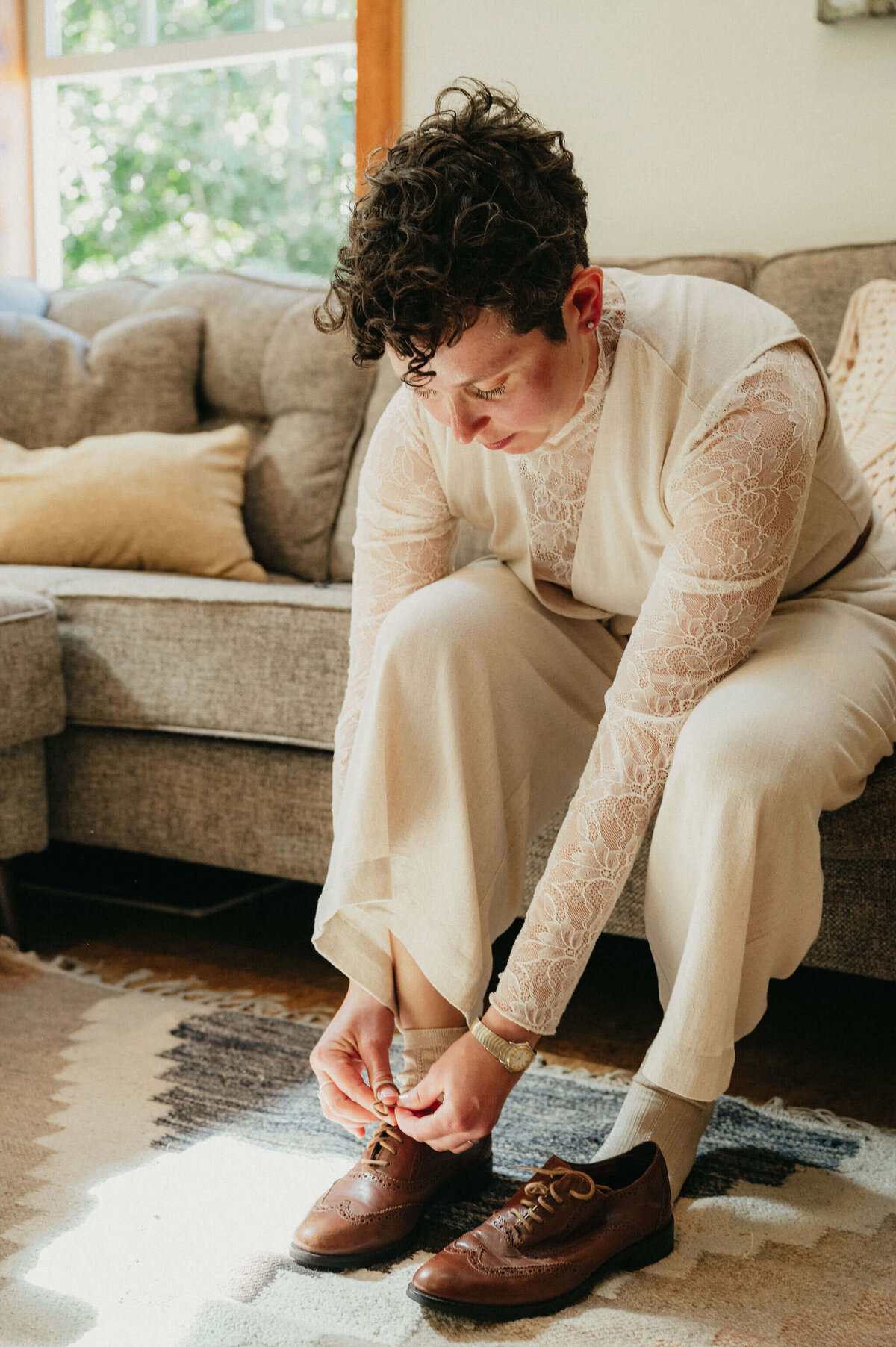 Person tying their shoes as they get ready for their wedding planned by Perfect Thirds and Co. 
