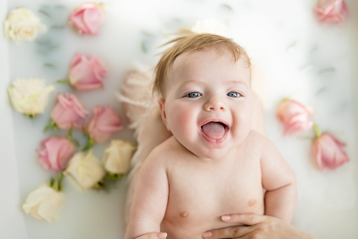 Mama holding baby during a Dallas milk bath photoshoot