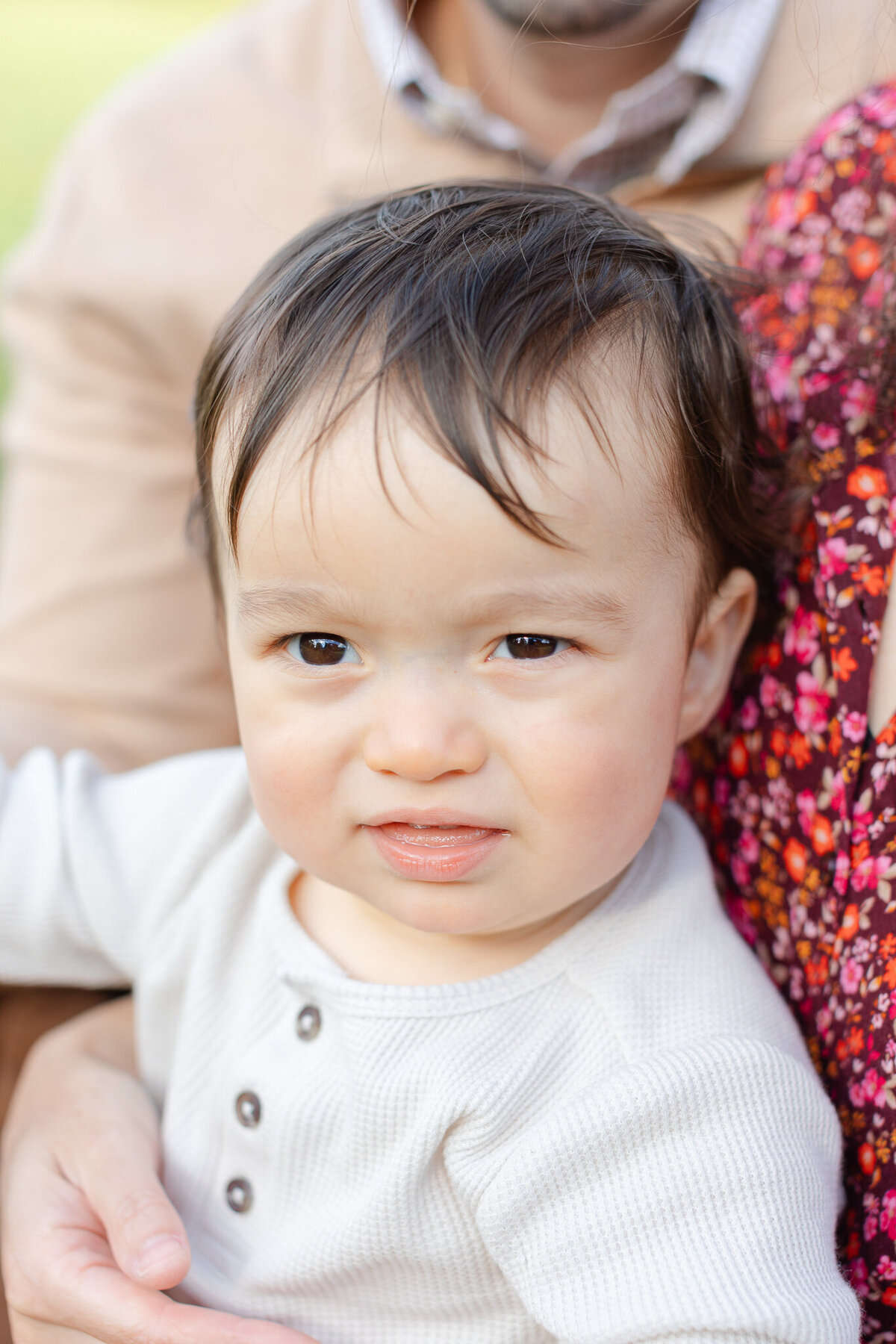 cute baby looks at camera during fall family photos