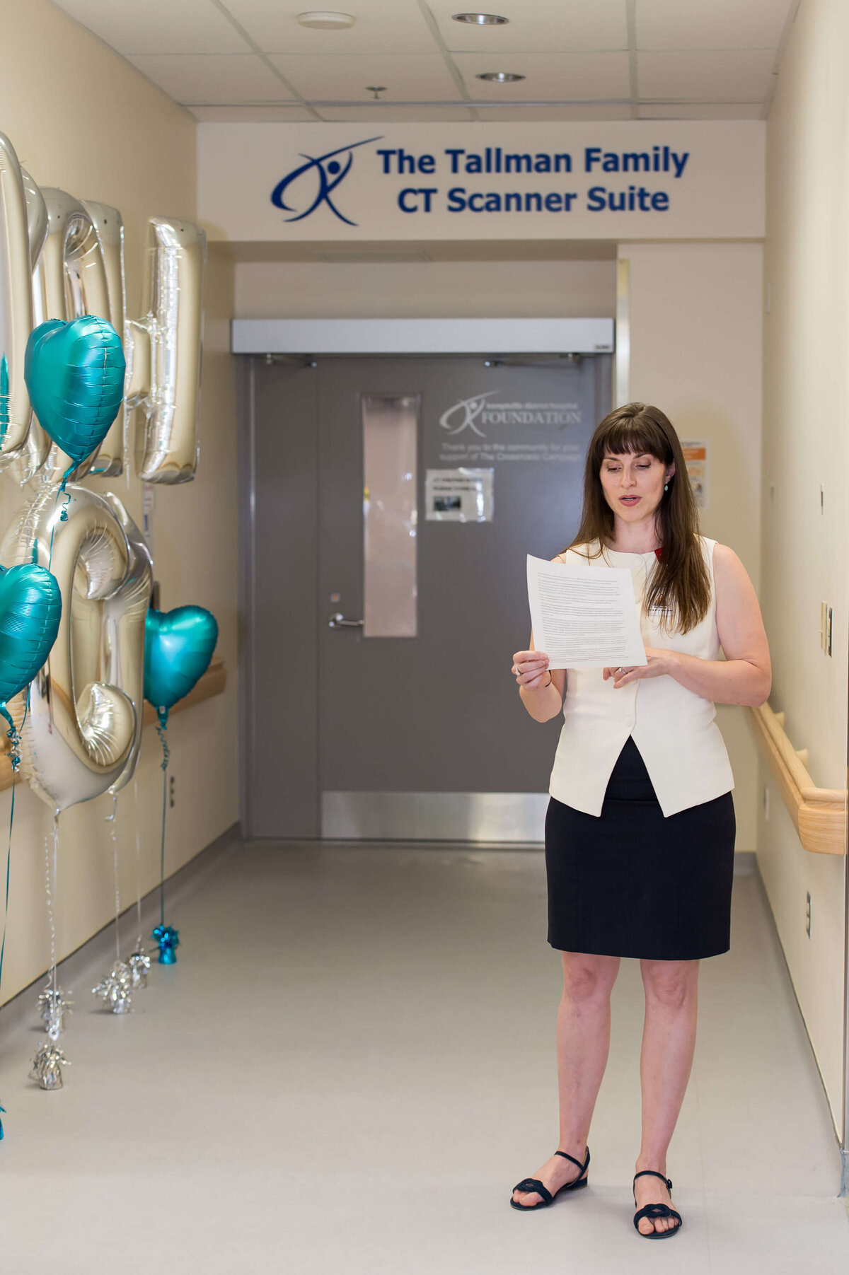 Ottawa event photography showing a KDH Finance CEO welcoming guests into the KDH CT Scanner Suite for a tour.  Captured by JEMMAN Photography COMMERCIAL