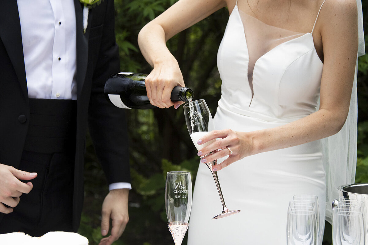 Couple pouring champagne at wedding