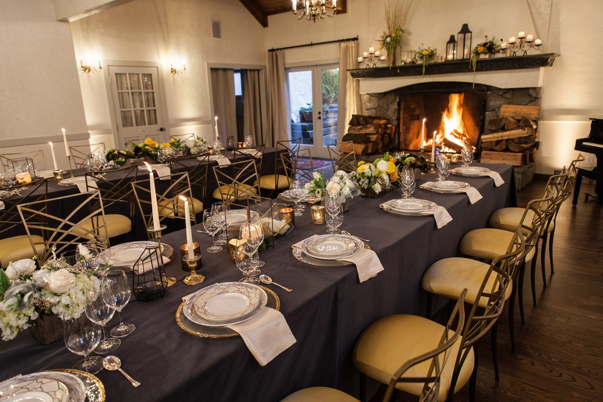 company dinner at ChateauLill with long tables, Chameleon chairs, and yellow floral centerpieces