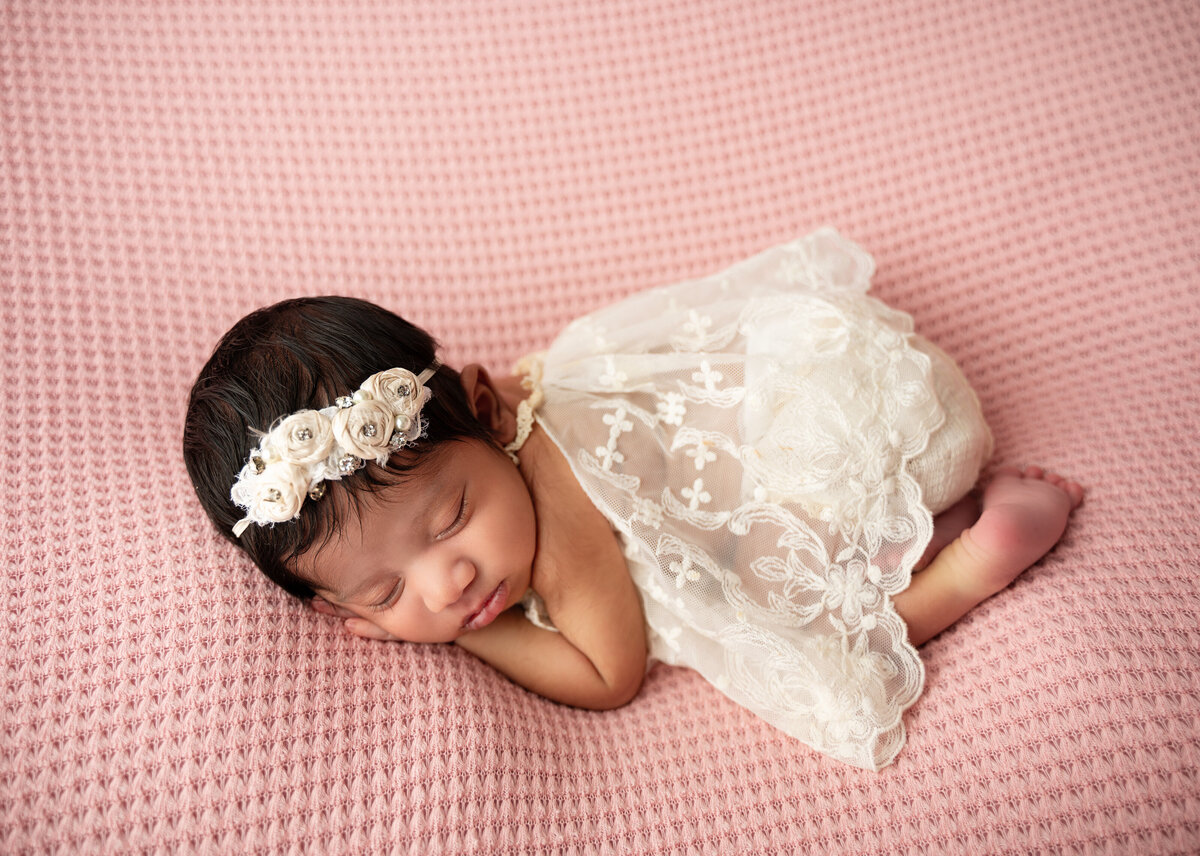 fort worth newborn baby girl in a white dress on pink