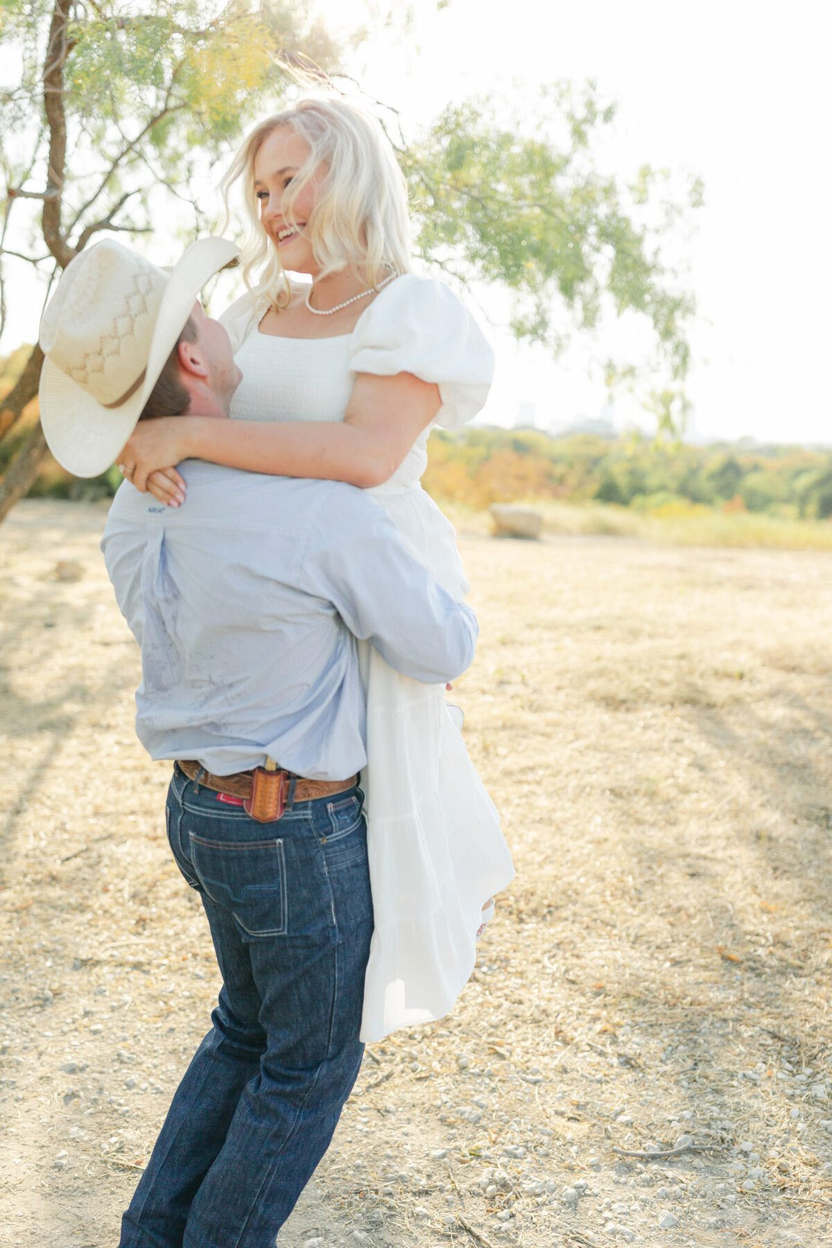 happy woman with fiance during texas engagement session