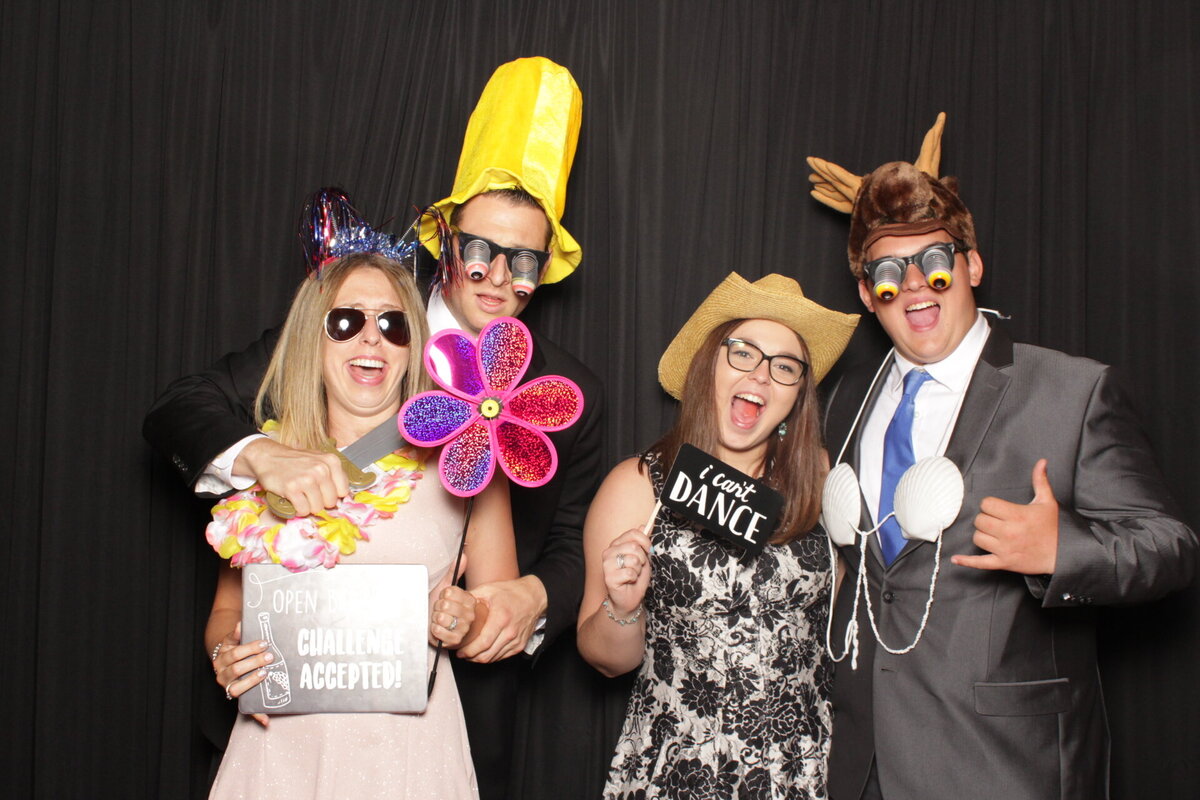 crazy friends having fun at wedding photo booth