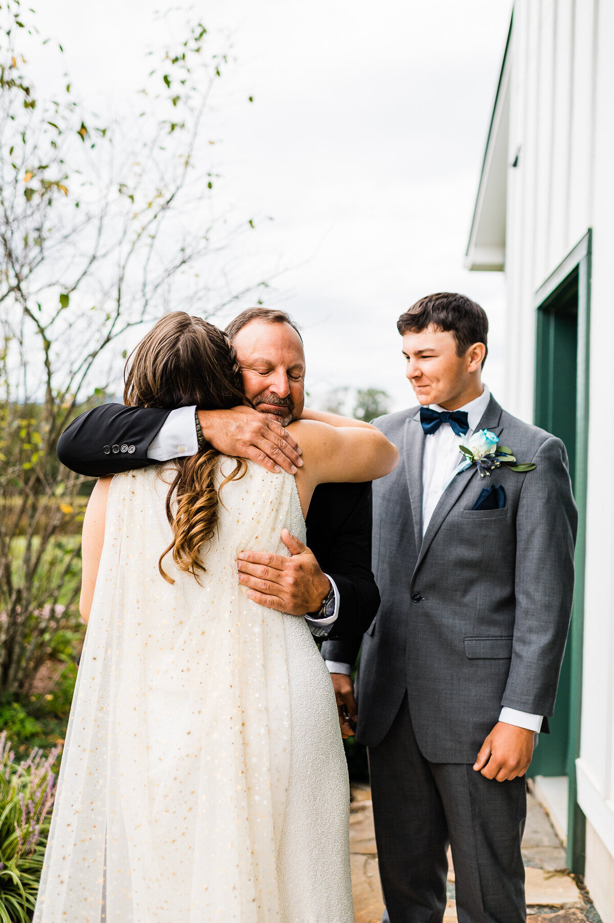 father of the bride hugging his daughter during their first look before the wedding ceremony