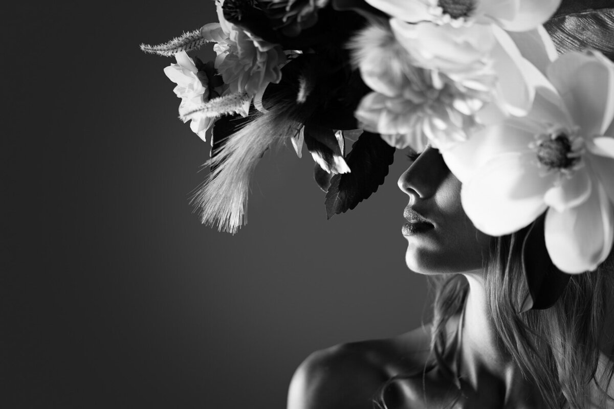 Artistic and elegant high-contrast silhouette profile of a woman wearing a floral crown against a dark grey background. Captured in Austin, TX.
