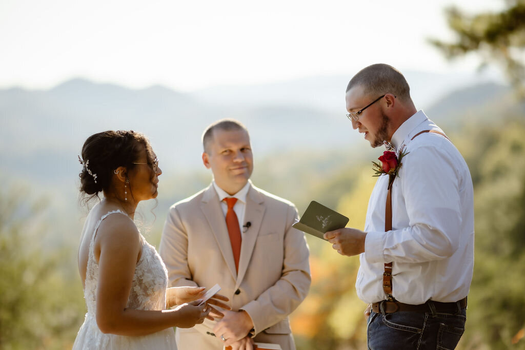 bride and groom holding vow books and sharing their vows together in the Foothills captured by Gatlinburg photographer