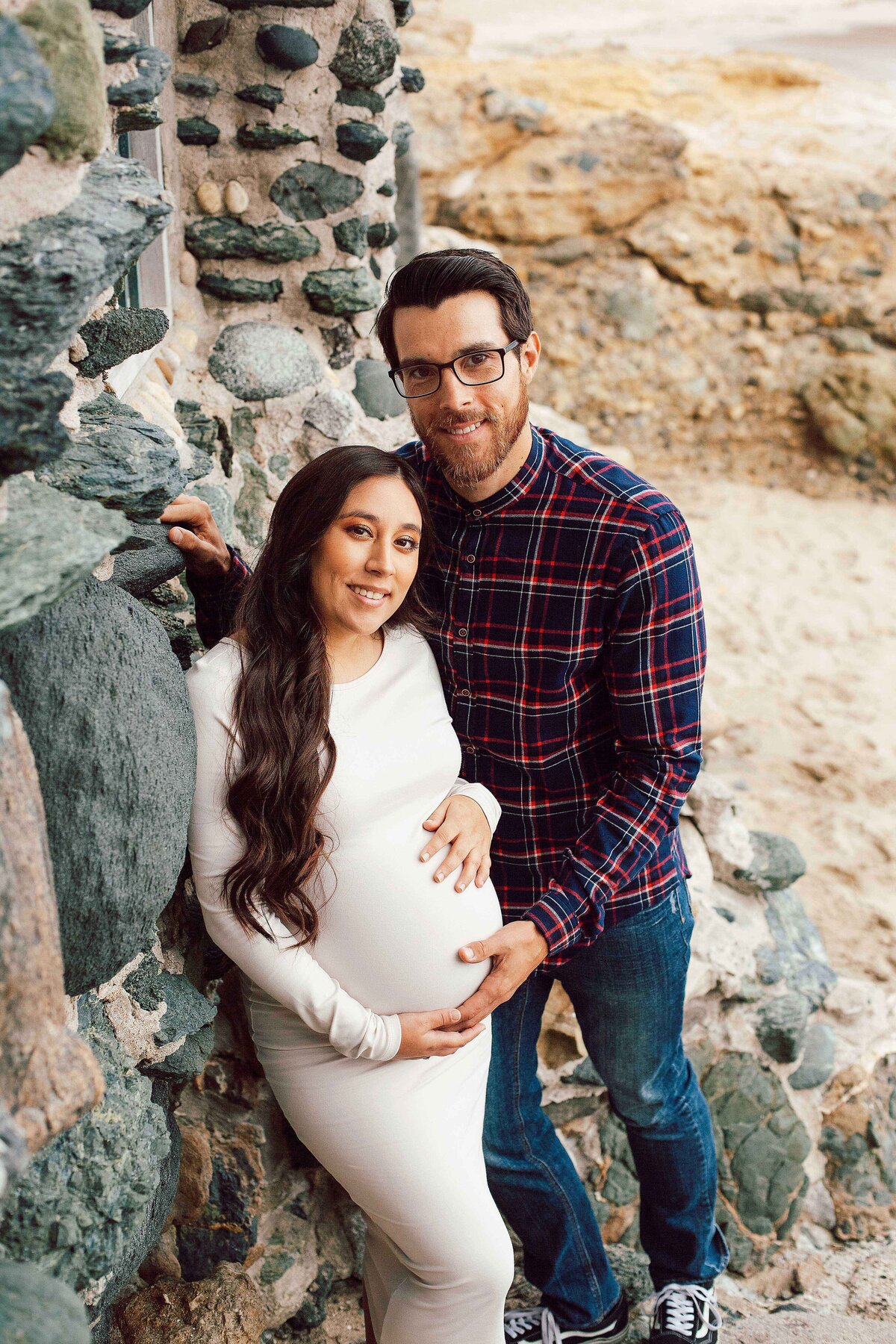 pregnant couple on the beach