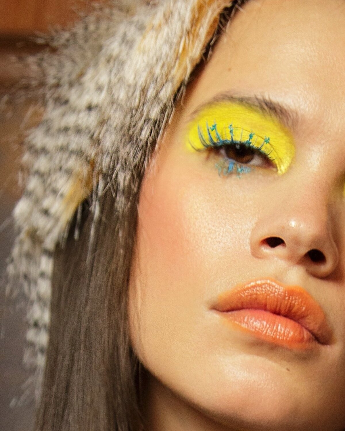 woman-colorful-editorial-makeup-feather-in-hair,