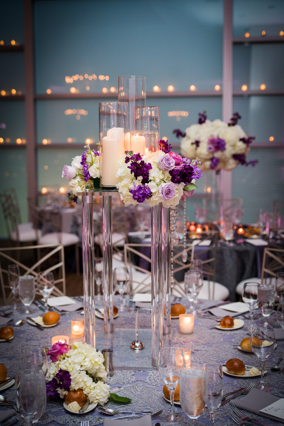 tall wedding centerpiece with white and purple flowers