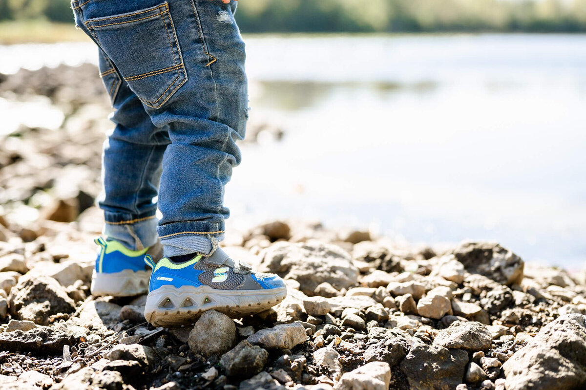 Toddler feet captured along the Fox River during family session in Geneva, IL.