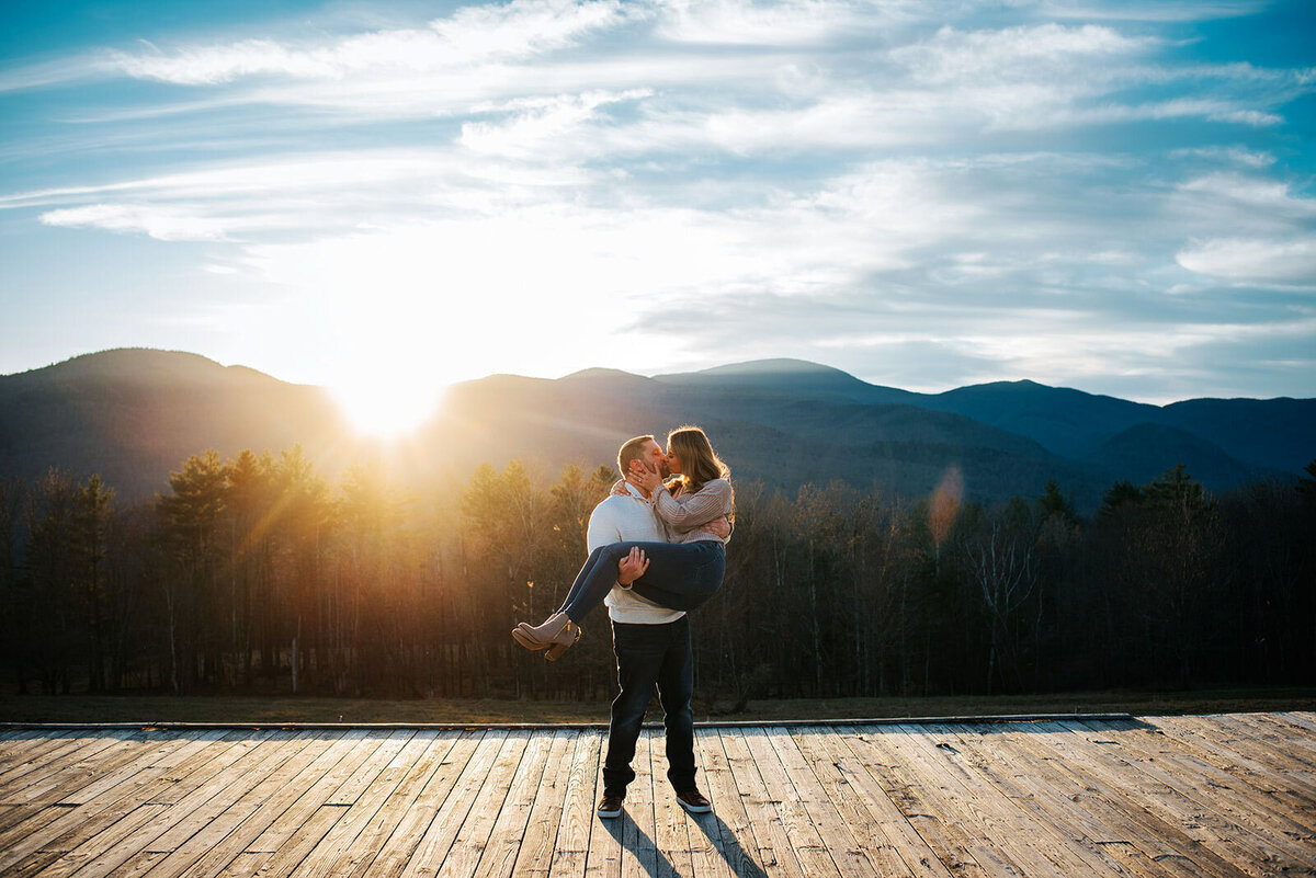 trapp family lodge engaged couple kissing at sunset