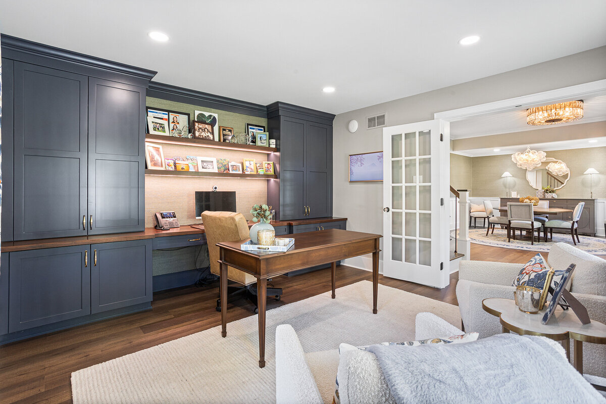 office space with blue built in cabinets and dark wood desk