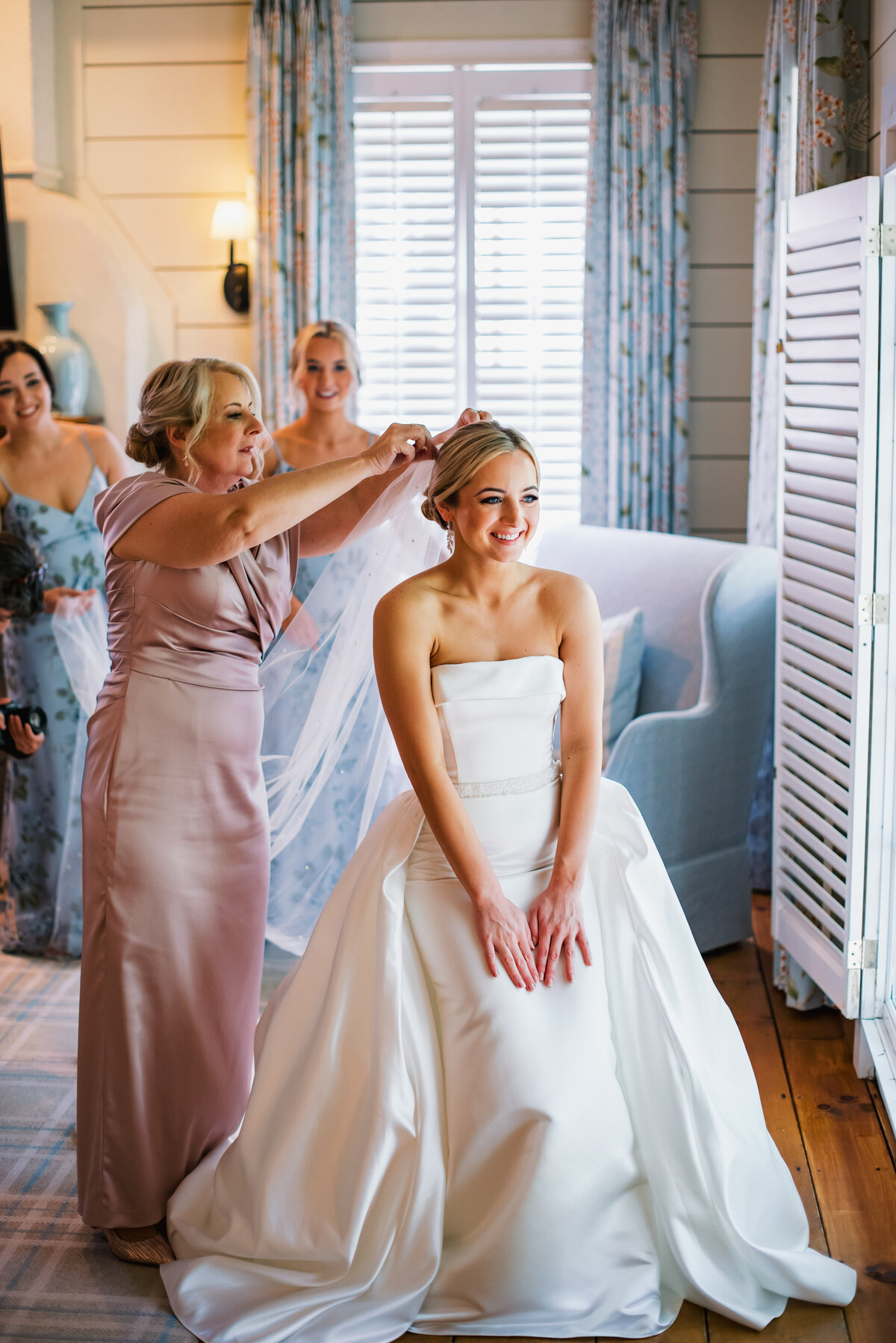 Mother placing veil on bride inside bridal suite at Old Edwards Inn during Highlands NC wedding.