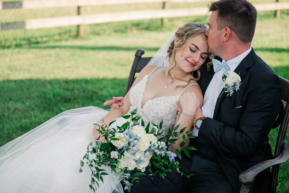 Bride-and-groom-sitting-on-bench