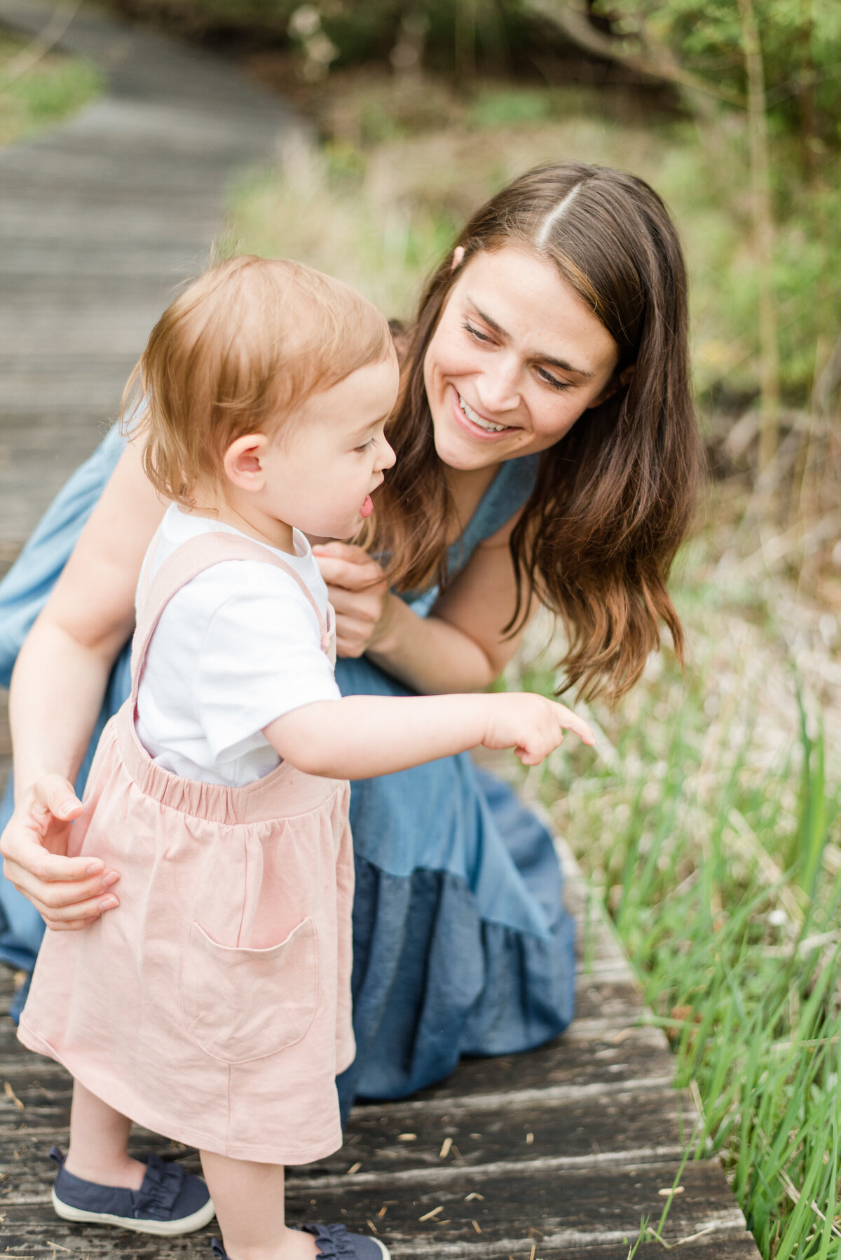 a mother bends down to her toddler during a Minneapolis portrait session