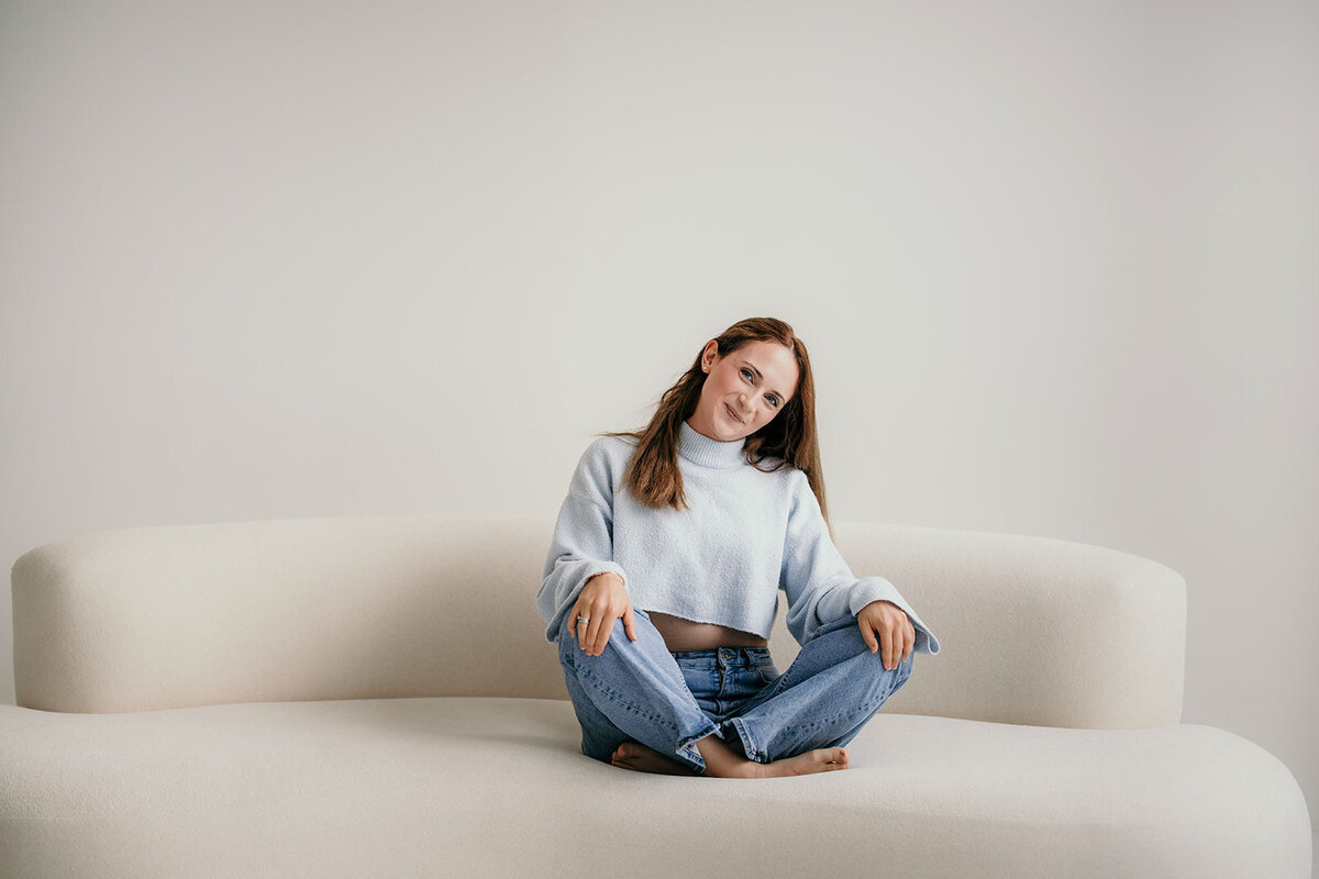 Woman sitting comfortably on a sofa.