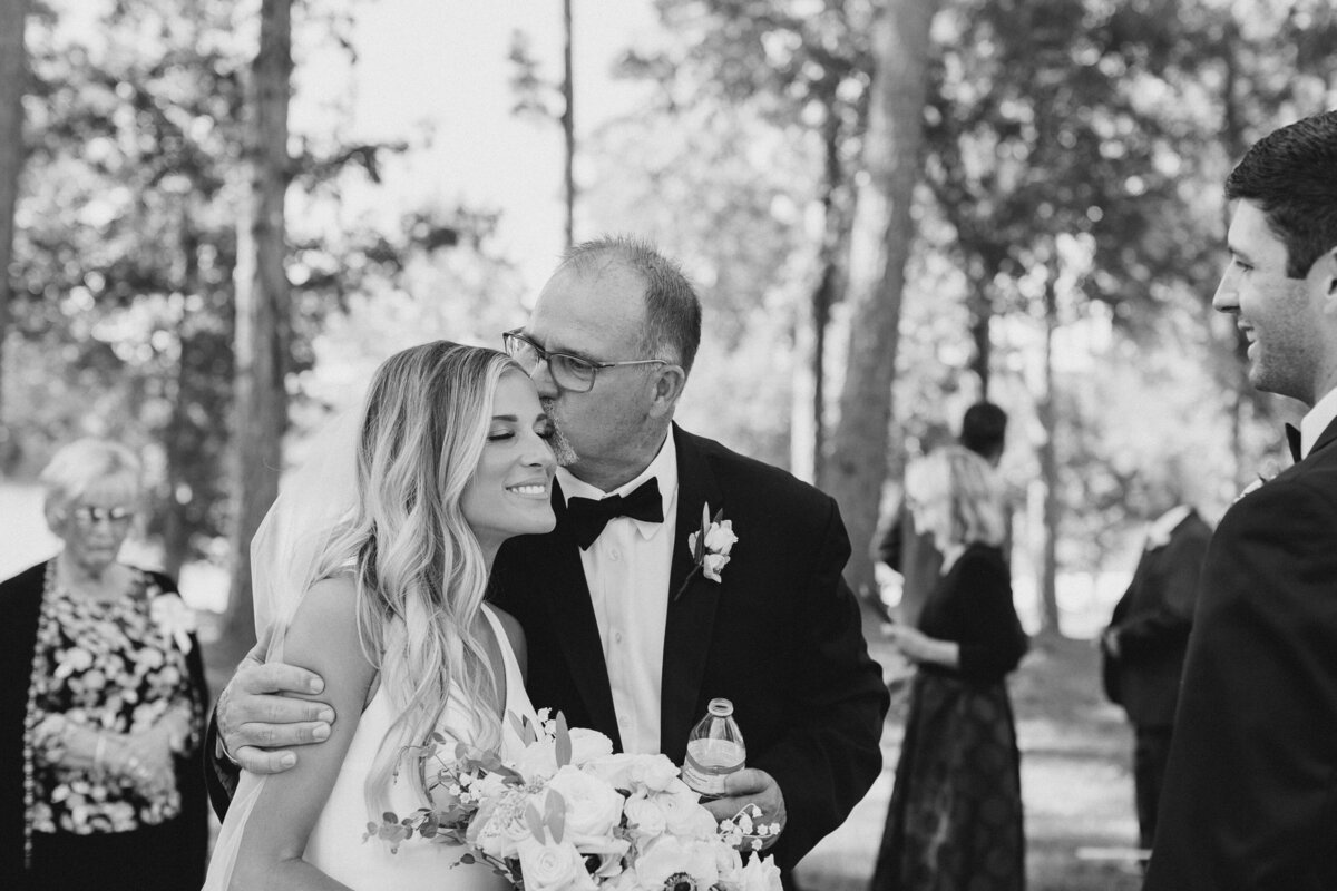 Father of the Bride kissing Bride