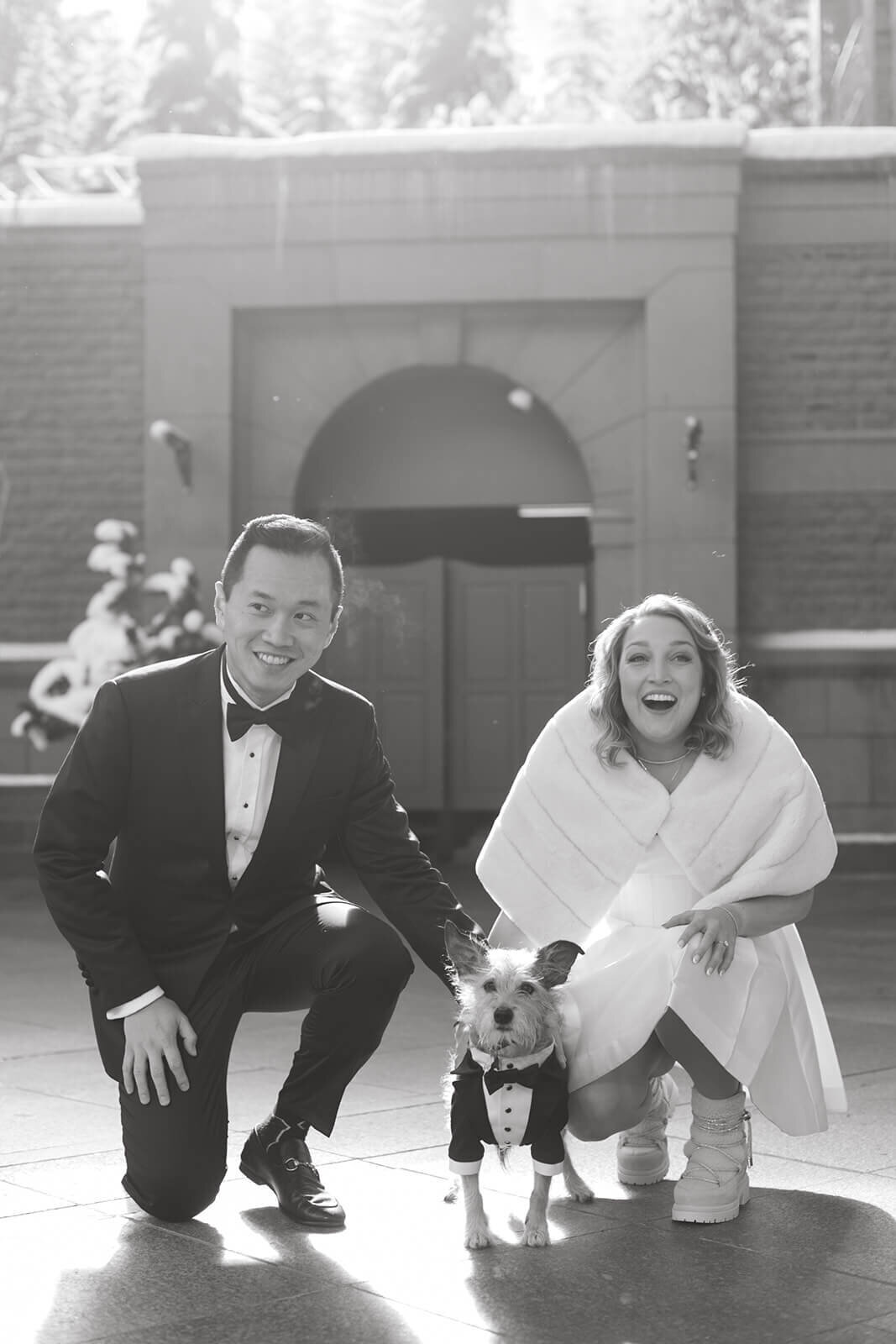 Bride and Groom pose with their dog outside of the Aspen St. Regis after their wedding ceremony.