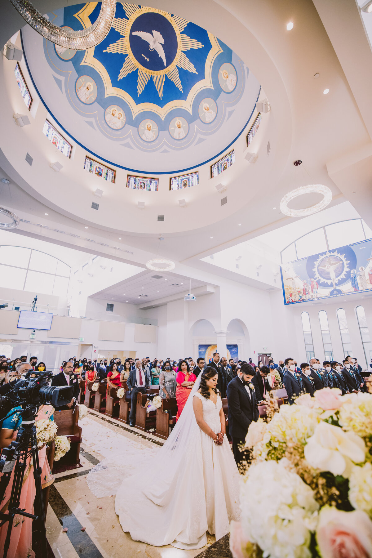 Indian christian malayali bride and groom praying during the ceremony at the st. mark's orthodox cathedral in paramus nj