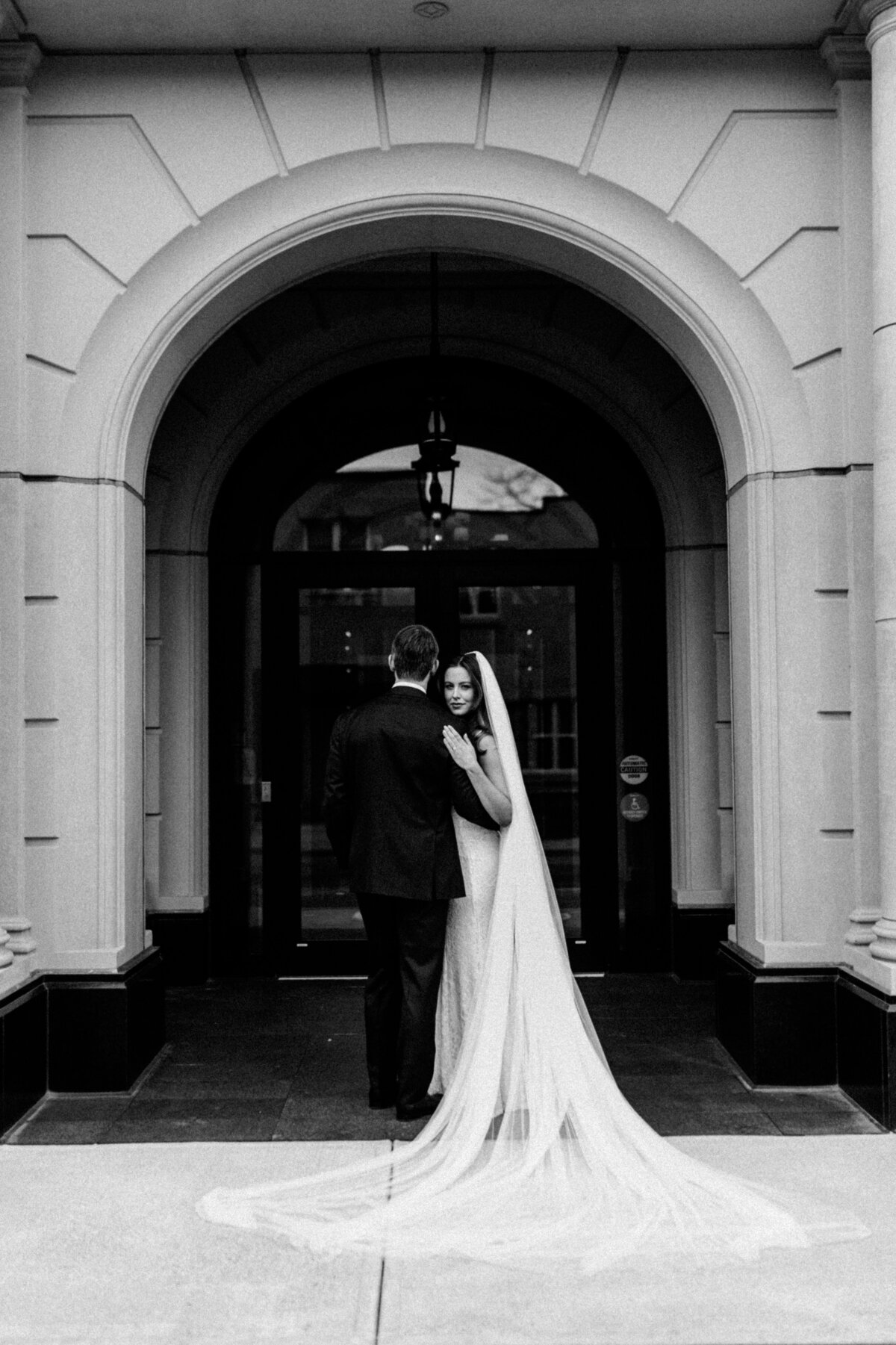 White and black portraits of Bride and Groom and posed with bride looking at the camera by the groom looks away