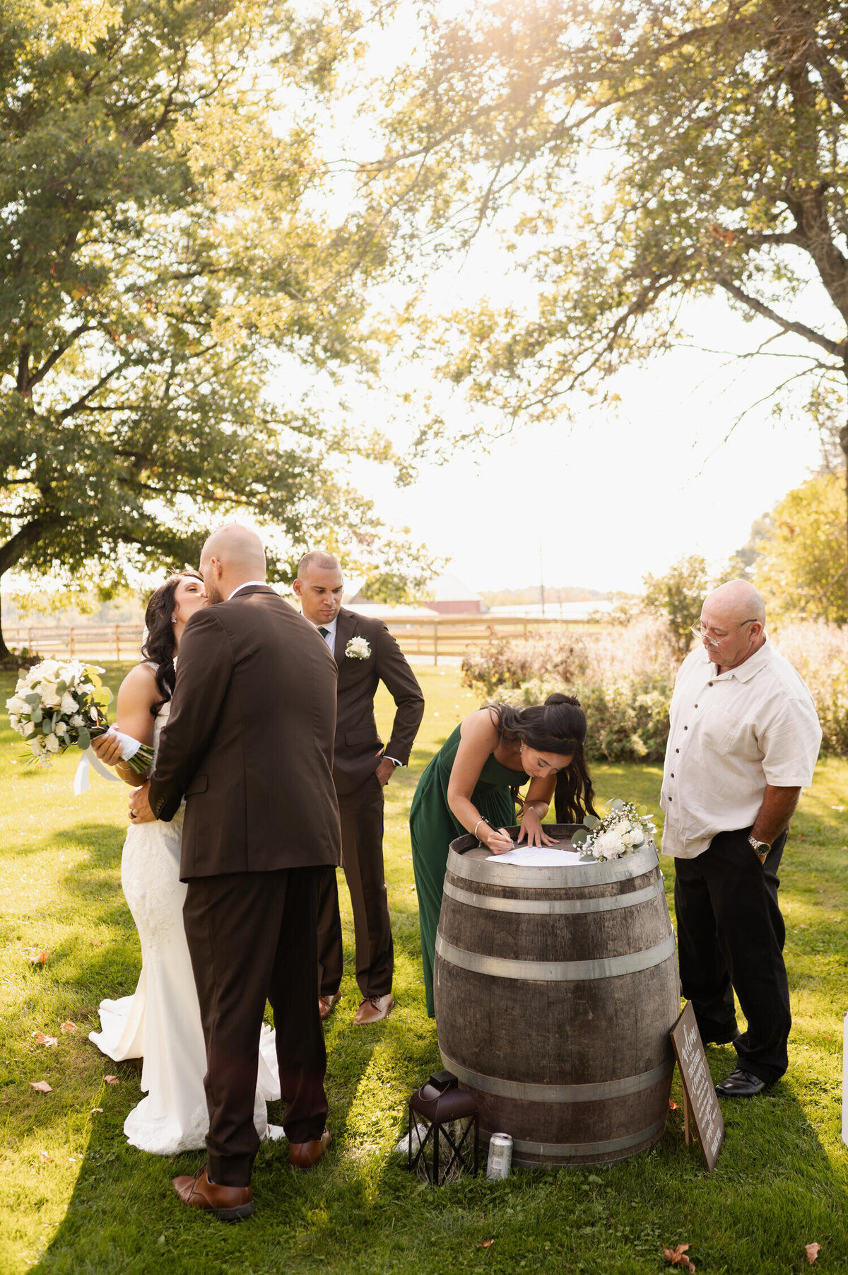 A candid photo of the marriage certificate being signed during a Fall wedding at Knotting Hill Farm in Jordanville, NY.