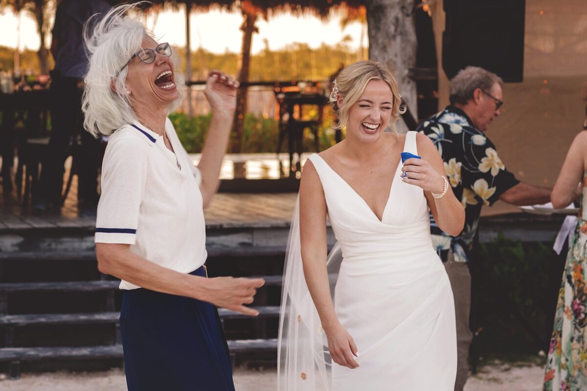 Bride laughing with guests at Blue Venado Seaside Riviera Maya wedding