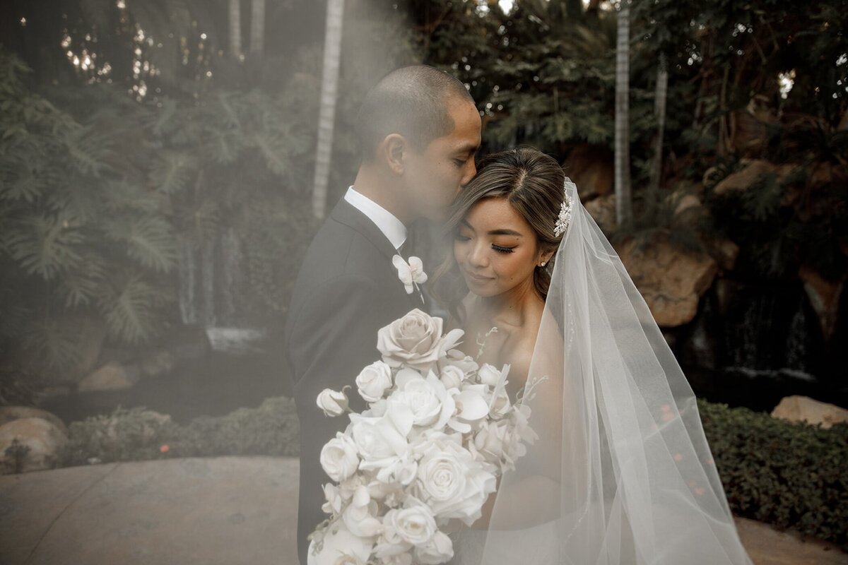 bride and groom embrace for wedding portraits at san diego wedding venue