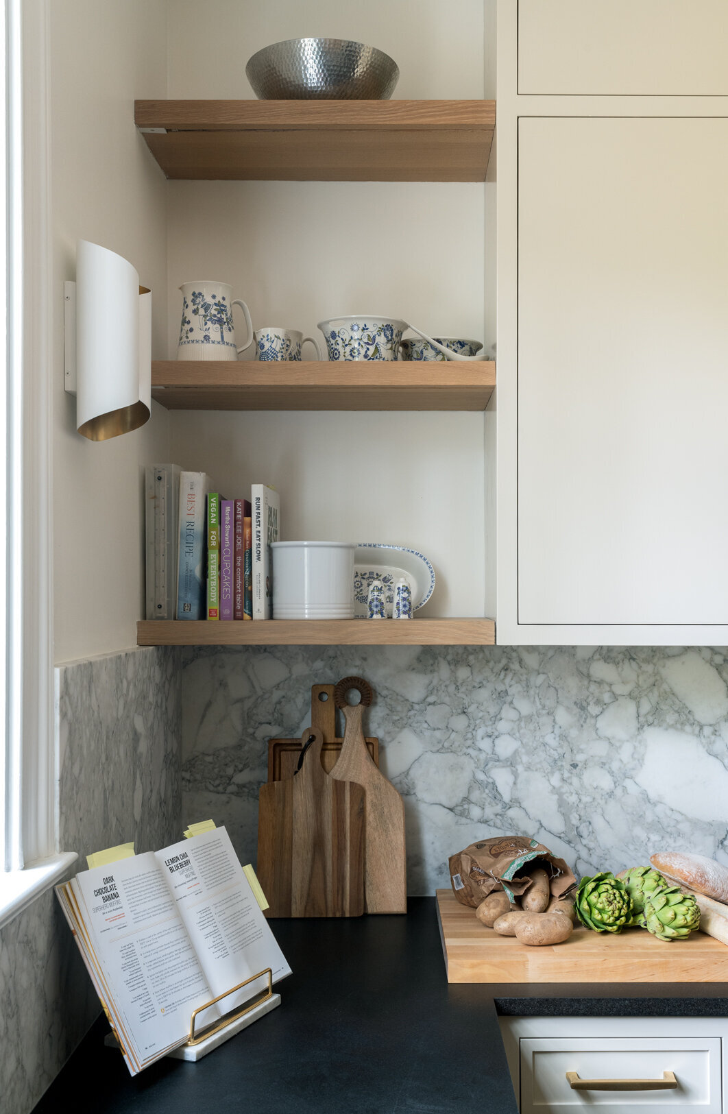 Open wooden shelves with books and dishes 